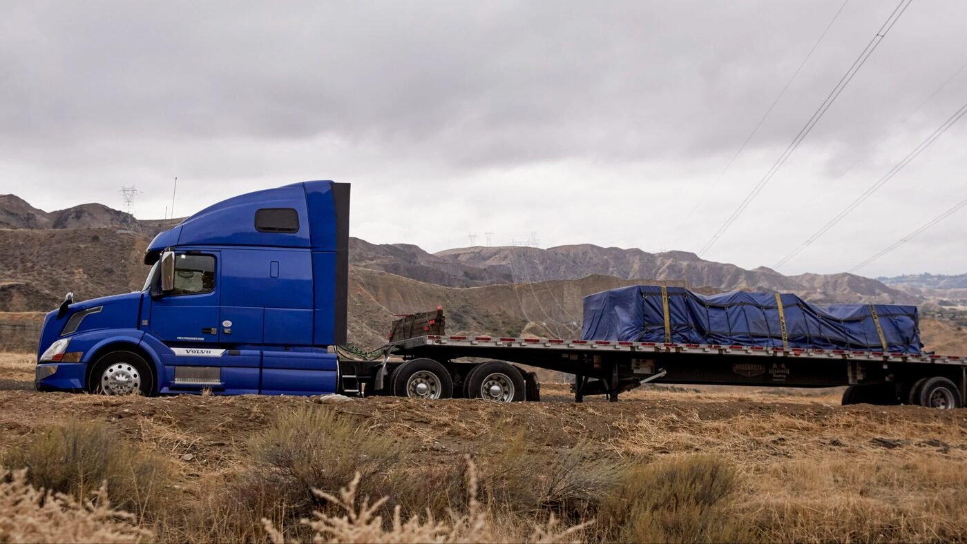 Flatbed trailer hauling a tarped load
