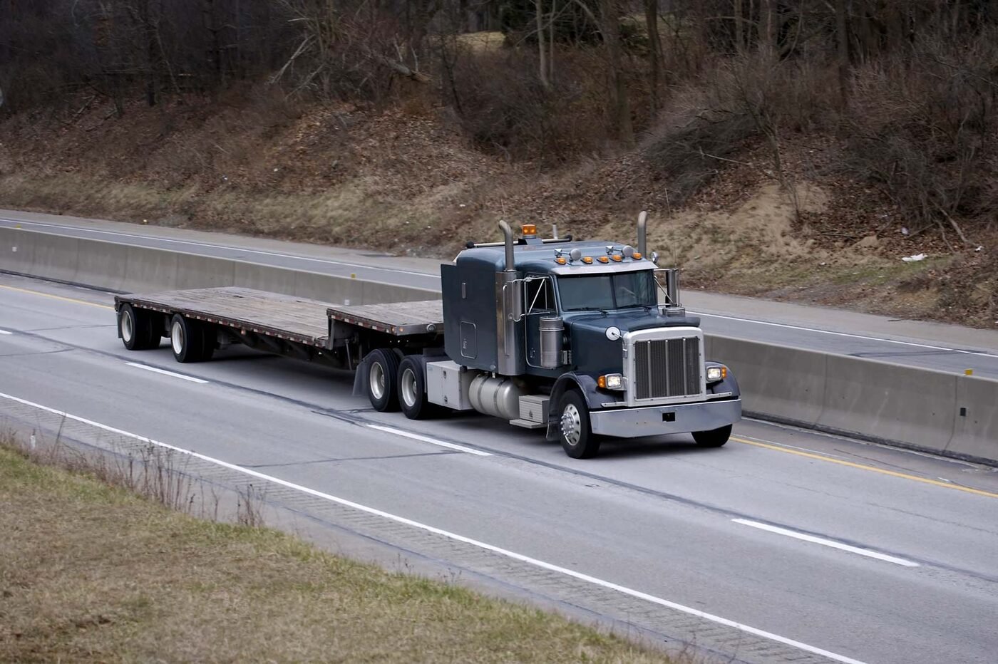 Step deck trailer on the highway
